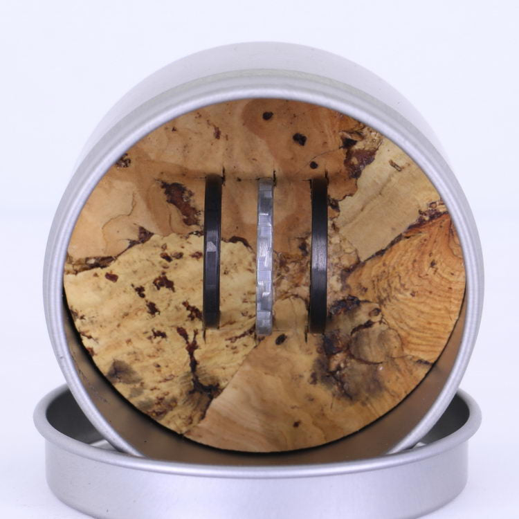 Stackable Rings, Carbon Fiber Racer, Quicksilver, and Bullet Carbon In Their Container Top View